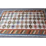 Kelim rug of geometric floral design on beige ground, 7ft x 4ft