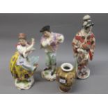 Pair of German porcelain dancing figures, (with damages and losses), together with an Imari figure