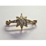Miniature yellow metal and rose cut diamond set star form brooch, overall width 25mm approximately