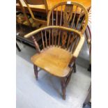 Early 19th Century elm hoop back Windsor chair with a spindle and pierced splat back, panel seat and