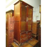 Modern oriental stained wood and brass mounted two door bookcase, 60ins x 34ins, and another smaller