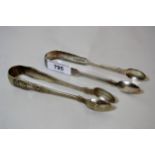 Pair of Victorian Newcastle silver fiddle pattern sugar tongs and a pair of Victorian Queens pattern