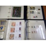 Four albums containing a collection of various stamps, including USA