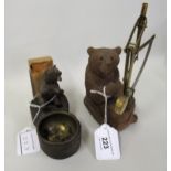 Black Forest souvenir match striker in the form of a seated bear, together with another similar,