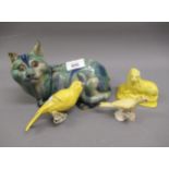 Oriental style stoneware figure of a reclining cat decorated in blue and green slip glazes,