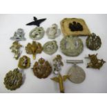 Small bag containing a collection of various military cap badges etc.