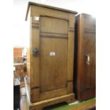 Aesthetic movement pot cupboard, with single panelled door and brass drop handle on shaped plinth