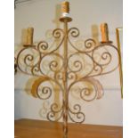 Painted wrought iron lamp standard with scroll work top above a tripod base, 63ins high