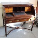 19th Century mahogany tambour desk opening to reveal a fitted interior with pull-out writing surface