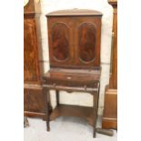 Edwardian mahogany side cabinet on stand, the shaped top with moulded cornice above two flush