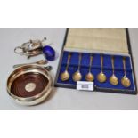 Modern small silver mounted and turned wooden bottle coaster, a cased set of six silver spoons and a