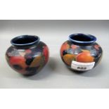 Pair of miniature Moorcroft squat baluster vases decorated with the pomegranite design, 2.5ins high,