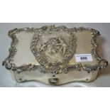Edwardian silver covered dressing table jewel box, with embossed decoration of figures in a
