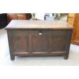 17th Century oak coffer, the hinged moulded plank lid above a carved frieze and three panel front on