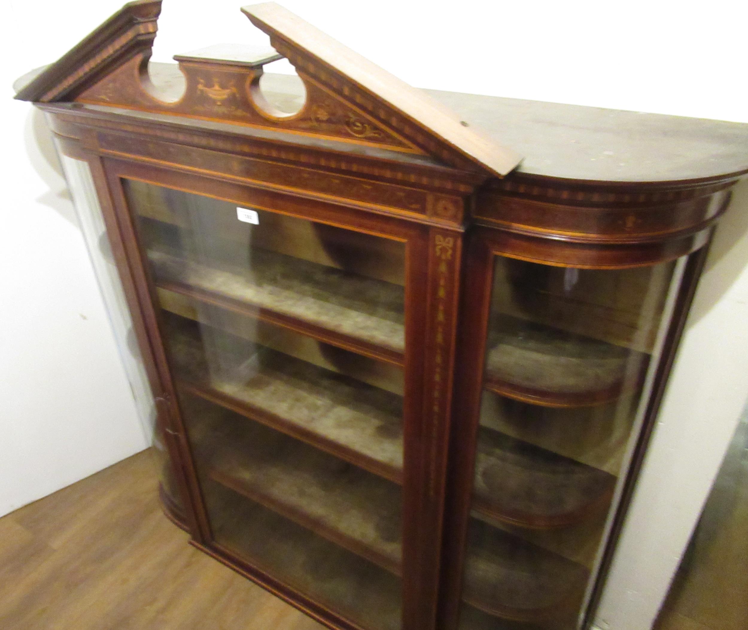 Edwardian mahogany and marquetry inlaid wall cabinet, the broken arch pediment above a glazed door