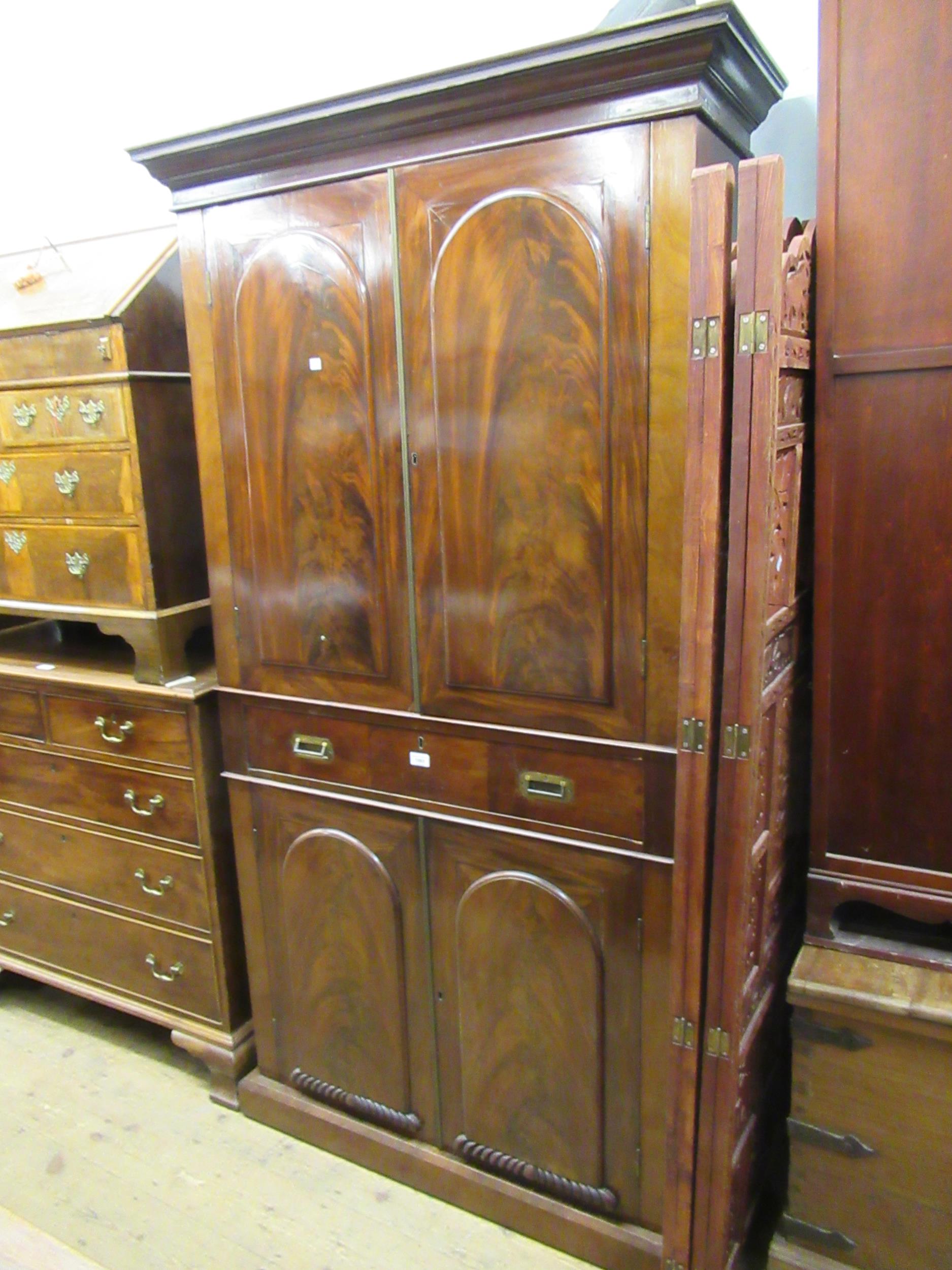 19th Century figured mahogany bookcase, the moulded cornice above a pair of arched figured panel