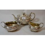 George III London silver floral embossed three piece teaset, with gilt interior (40 troy ounces)