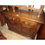 20th Century oak low side cabinet, the moulded top above two drawers and two panelled doors, 26ins