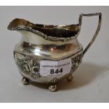 Birmingham silver floral embossed cream jug on low ball supports, dated 1902