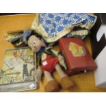 Vintage Pinocchio felt doll, together with a related book, a doll's suitcase containing