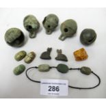 Five early bronze cattle bells, small quantity of stone scarab beetle beads, a pair of beads in