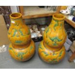 Pair of large 20th Century Chinese pottery gourd shaped vases, decorated with bats in green on a