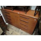 Mid 20th Century G Plan teak side cabinet of eight drawers, 56ins wide together with a mid 20th