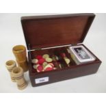 Mahogany cased games box containing collection of various red stained bone counters