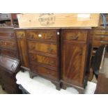 Reproduction mahogany crossbanded low breakfront side cabinet with an arrangement of drawers and