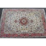 Modern Tabriz part silk carpet with a medallion and all-over floral design on an ivory ground with