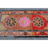 Small Tibetan rug with a triple medallion and polychrome design, 5ft 6ins x 2ft 10ins