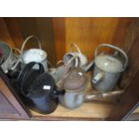 Four various galvanised watering cans