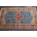 Turkish rug with central medallion in shades of red, blue and orange with a multiple border, 8ft x