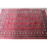 Pakistan rug of Turkoman design with three rows of ten gols on a red ground, 6ft x 4ft 2ins