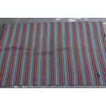 Flatweave rug of polychrome striped design in shades of red, black, green, blue and cream, 7ft x 4ft