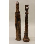 Continental carved and stained pine figure of a Saint, together with a carved wood candle stand