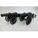 Pair of black painted cast metal signal type cannon