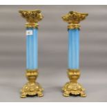 Pair of ormolu and blue vaseline glass candle stands (chip to one), 15ins high