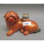 18th Century Chinese altar candlestick in the form of a reclining foe dog, decorated in iron red and