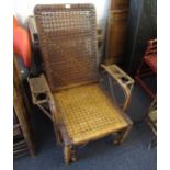 Early 20th Century bamboo recliner chair with pull-out foot rest, in the style of Maple & Co.