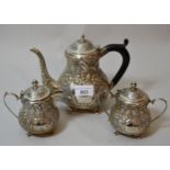 Pakistani white metal three piece tea service, with floral embossed decoration, 21 troy ounces