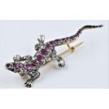 9ct yellow gold lizard brooch set with rose cut rubies and diamonds, measures 6cm x 2cm