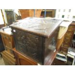 Late 19th / early 20th Century carved oak coal box with a hinged sloping lid, 21ins wide