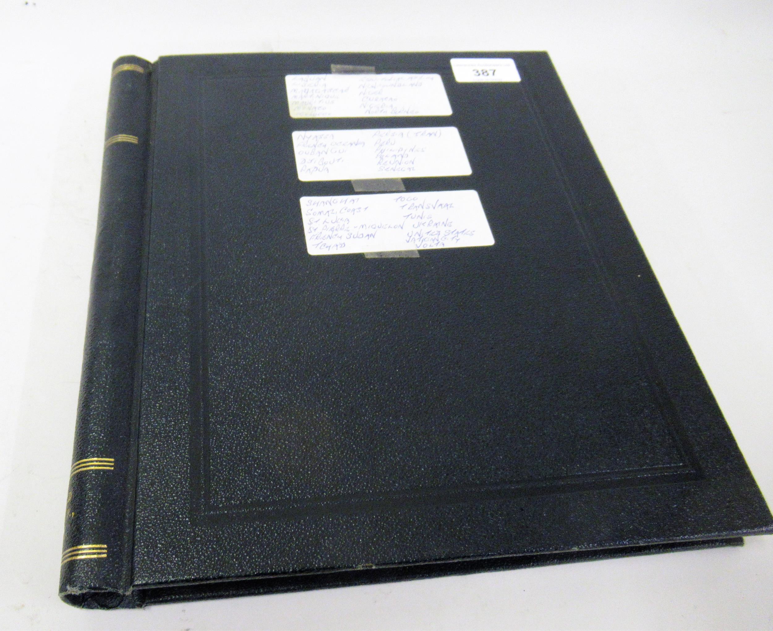 Black album containing a collection of World stamps, including Liberia