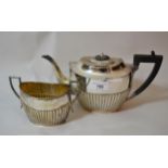 Sheffield silver two piece tea service of half gadroon decoration with ebony handles, 26 troy ounces