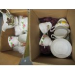 Two boxes containing a quantity of various floral decorated teacups and saucers, including a set