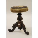 Victorian rosewood piano stool with a needlepoint swivel seat above a turned fluted column and