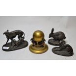 Two spelter figures of greyhounds, a gilt brass ink stand with three greyhound supports and a bronze