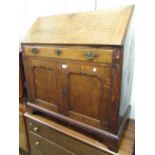 19th Century oak bureau, the fall front enclosing fitted interior above a single drawer and two