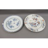 Two Chinese circular plates, one decorated with birds in foliage, the other blue and white,
